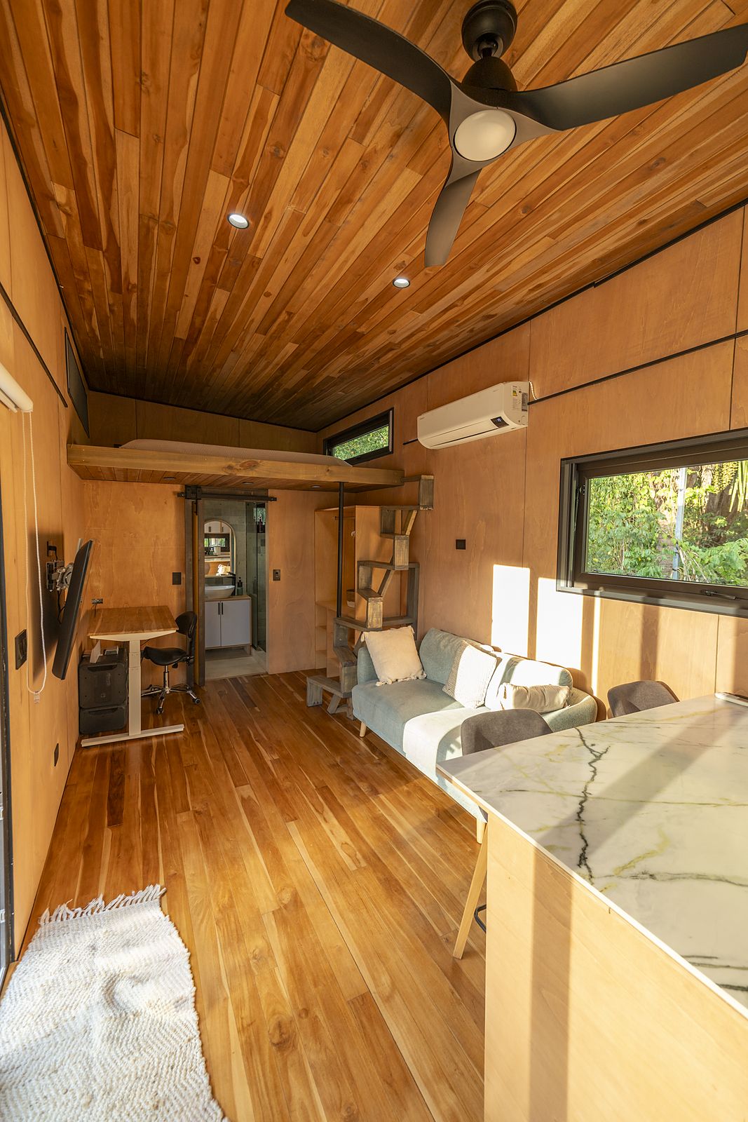 Atenea living area with sofa and workspace