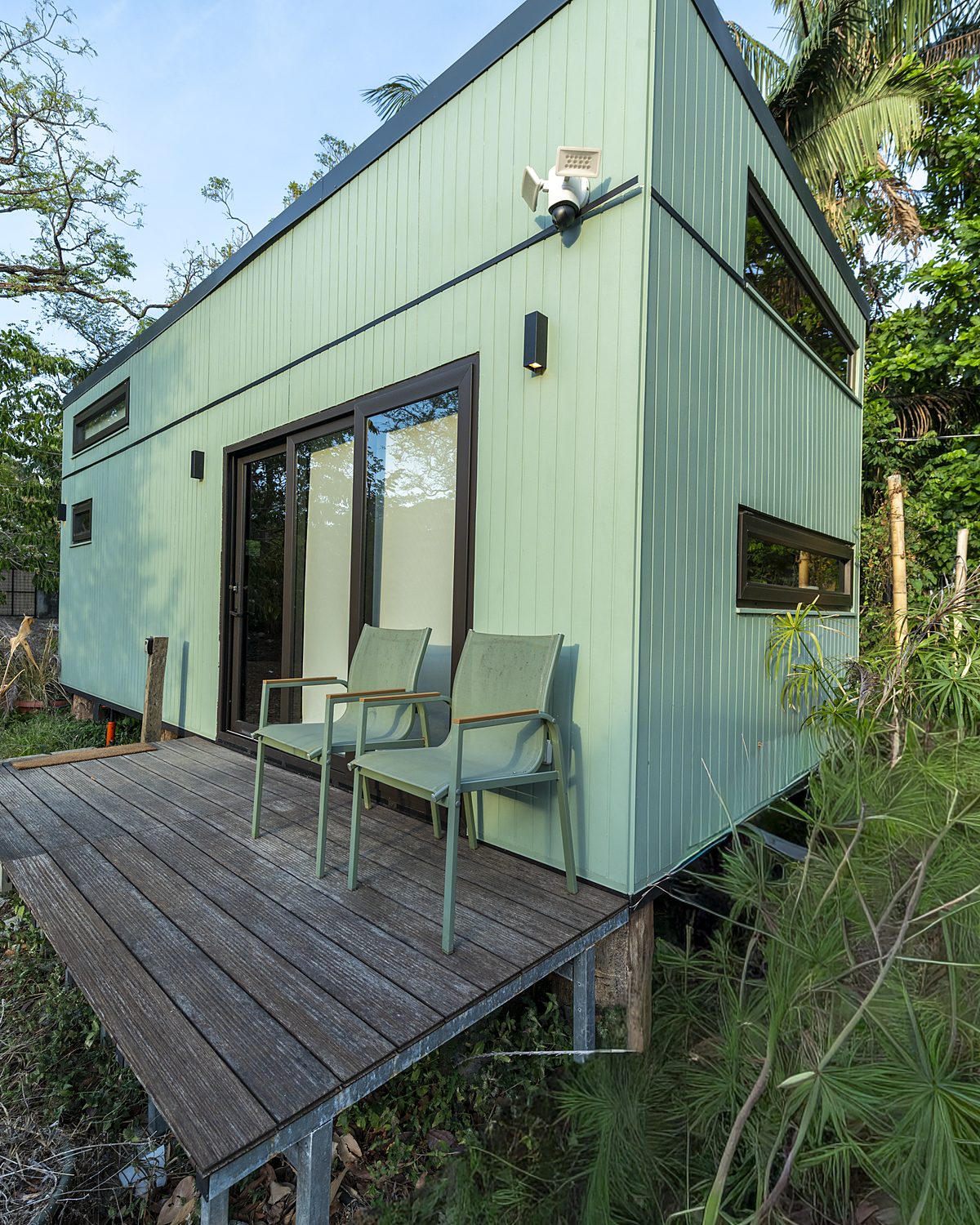 Atenea eco tiny home with wooden deck surrounded by jungle in Nosara, Costa Rica